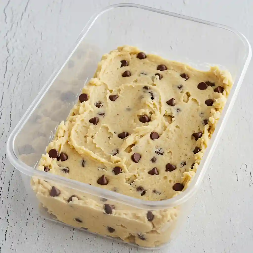 Gluten free dairy free cookie dough with chocolate chips in clear container ready for baking