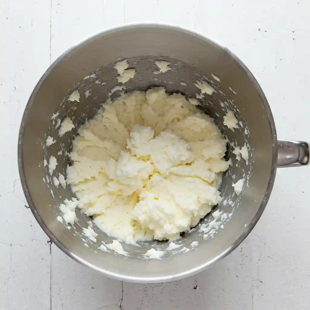 Creamed coconut oil and sugar mixture for gluten free dairy free cookies in metal mixing bowl