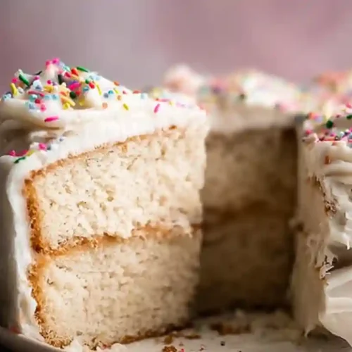 vegan gluten free cake with sprinkles and creamy frosting, showing a moist, fluffy texture and perfect for celebrations or special occasions