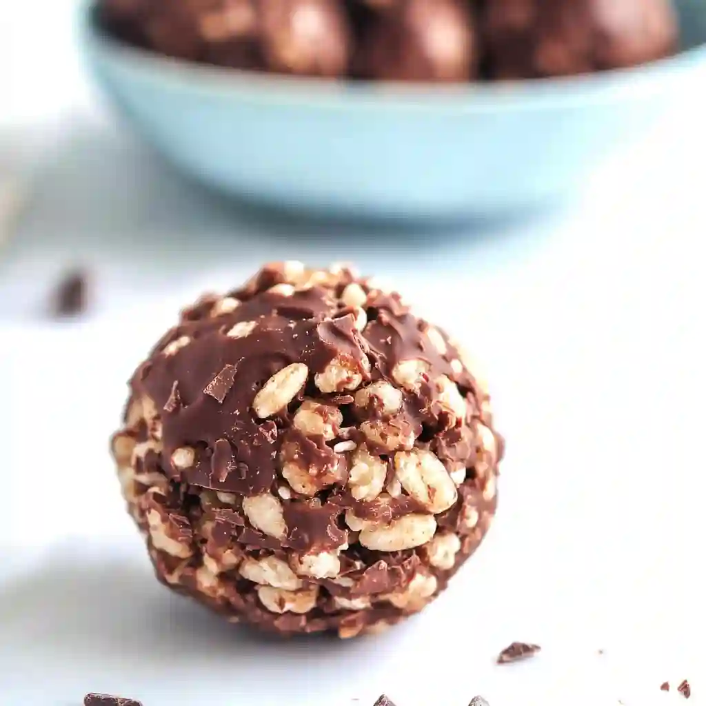An overhead shot of a light blue bowl filled with treats from a Chocolate Rice Krispie Balls Recipe