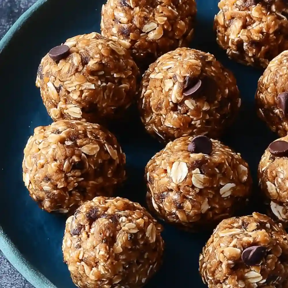 Assortment of different flavored no-bake protein balls displayed with core ingredients like oats and nut butter for a healthy snack guide.

