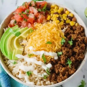 Traditional Okinawan Taco Rice served with shredded lettuce, cheese, and tomatoes.
