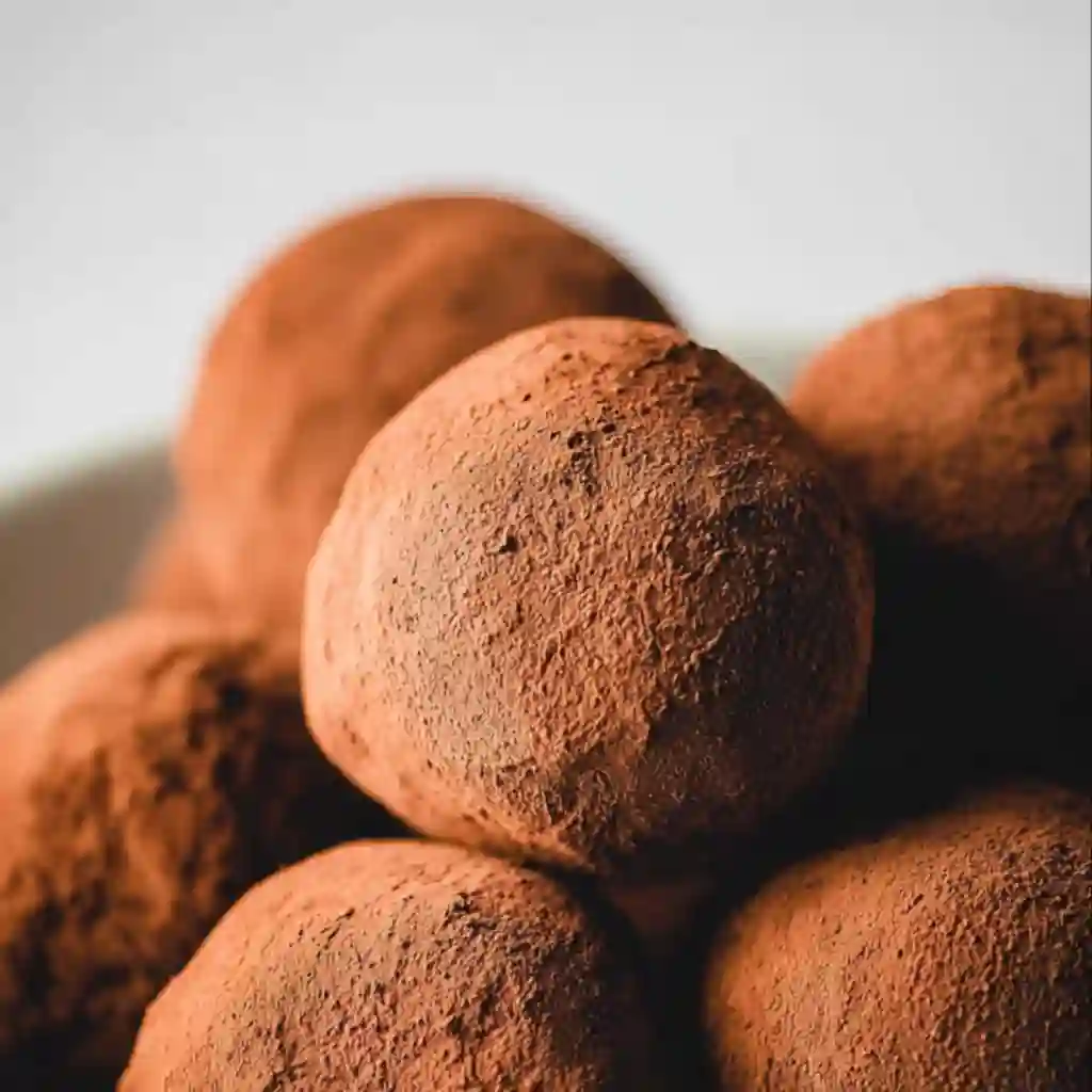 Chocolate ganache preparation and cross-section of a finished truffle.