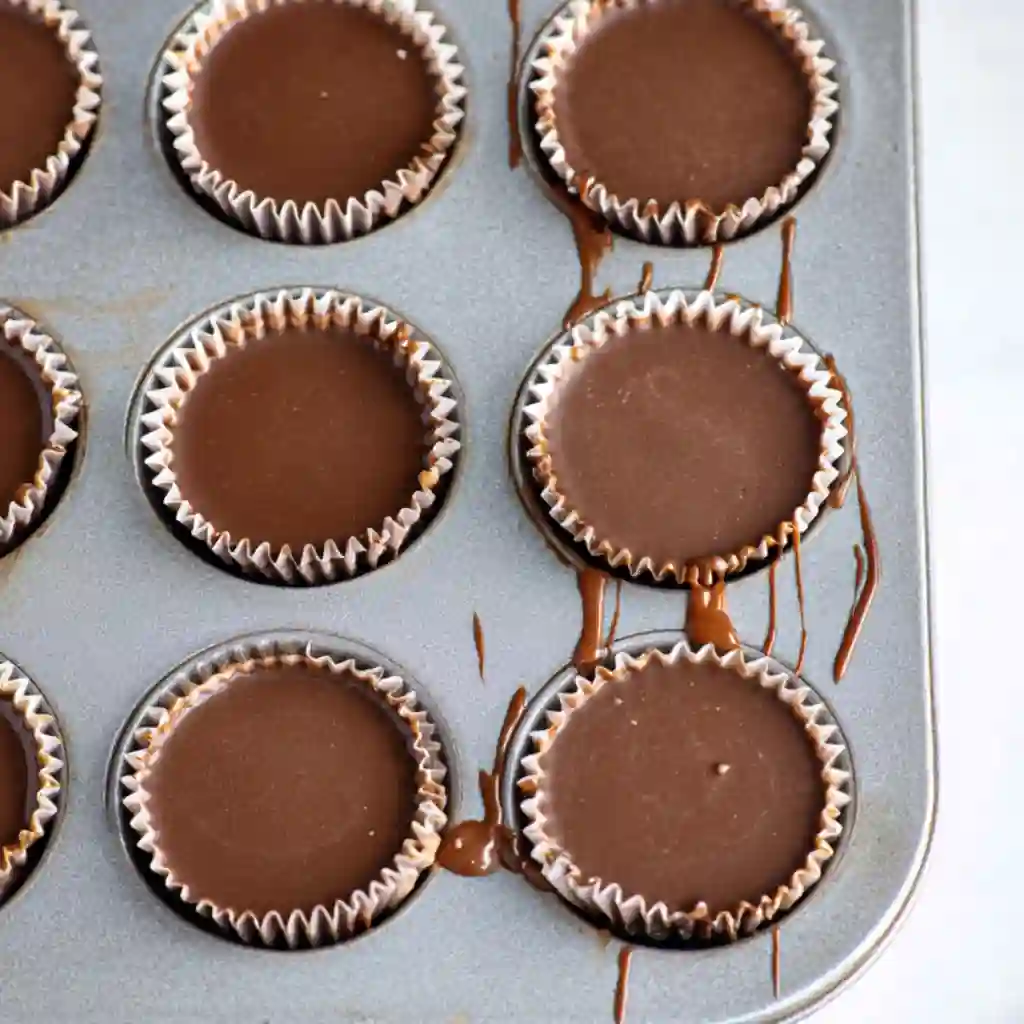  Ingredients for Homemade Reeses Cups including chocolate chips, peanut butter, and graham cracker crumbs.