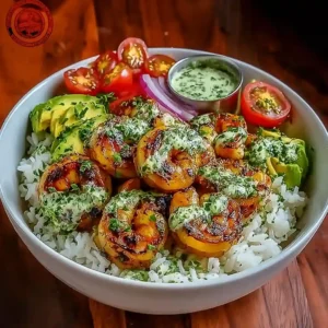 Top-down view of Zesty Shrimp And Avocado Rice Bowls with cilantro lime sauce and fresh toppings.