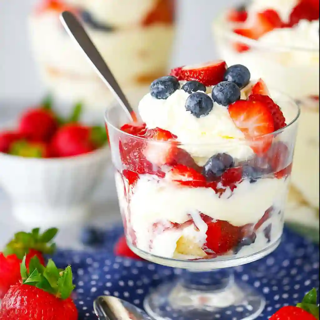  Close-up view of the layers in a fruit trifle dessert recipe showing sponge cake and custard.