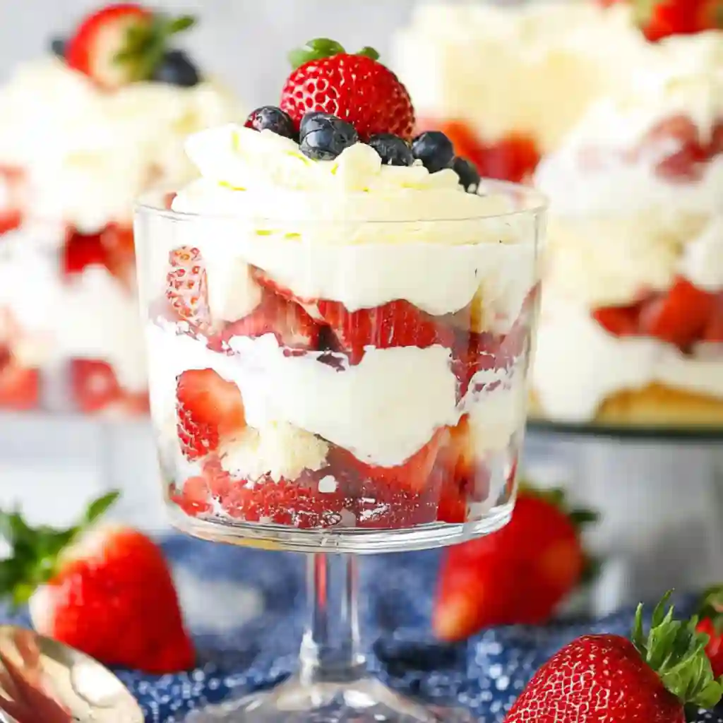 Close-up view of the layers in a fruit trifle dessert recipe showing sponge cake and custard.
