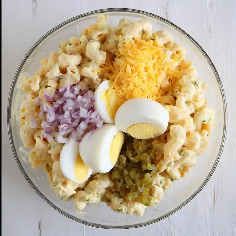Serving deviled egg pasta salad at an outdoor summer BBQ picnic.